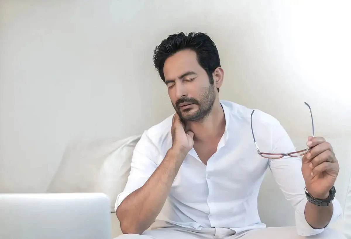 Man in white shirt and glasses demonstrating product comfort