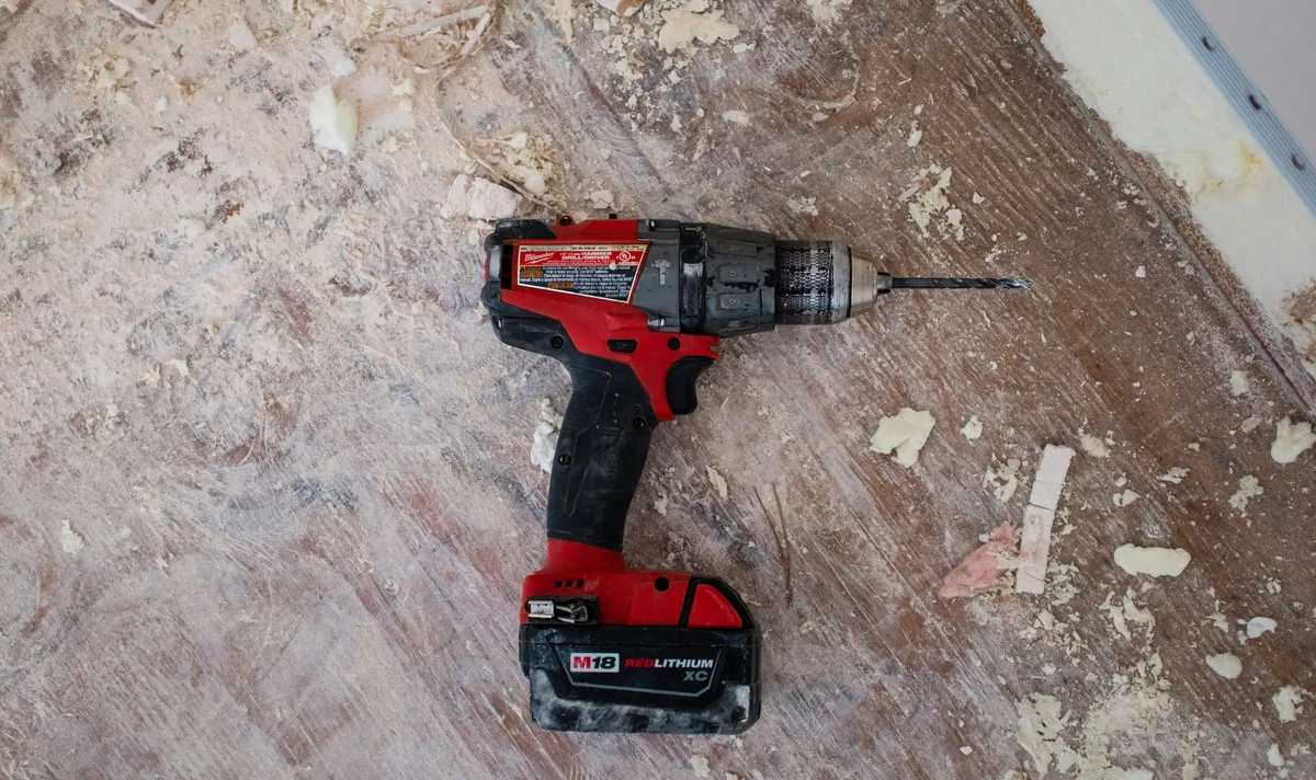 Cordless drill and hand tools ready for a repair