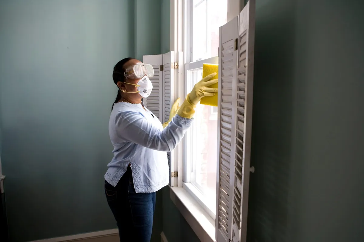 Person cleaning a bright living room floor