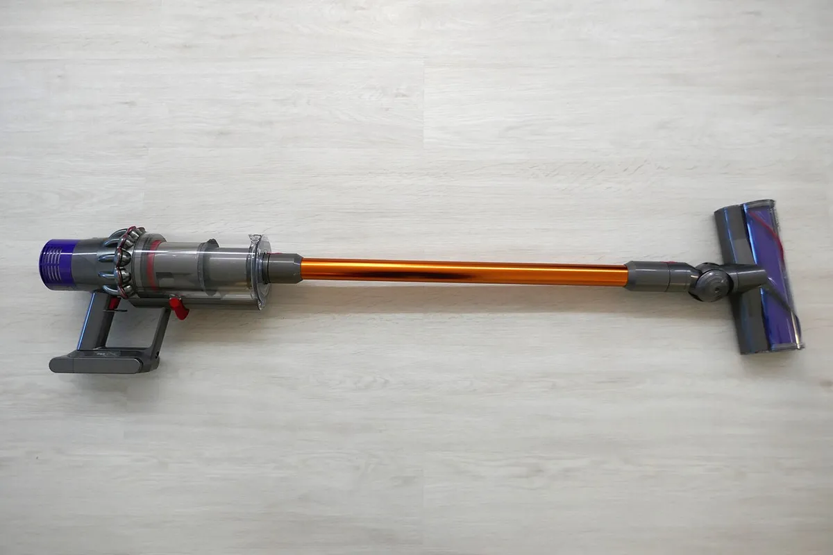 Dyson cordless stick vacuum cleaner head on a hardwood floor