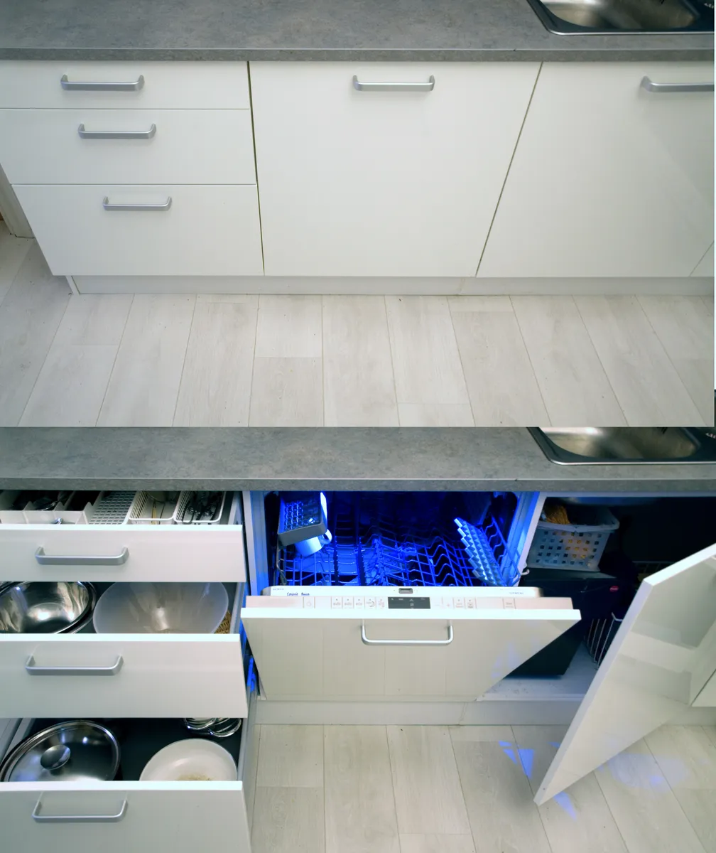 Kitchen cabinetry with a fully integrated dishwasher hidden behind a matching door