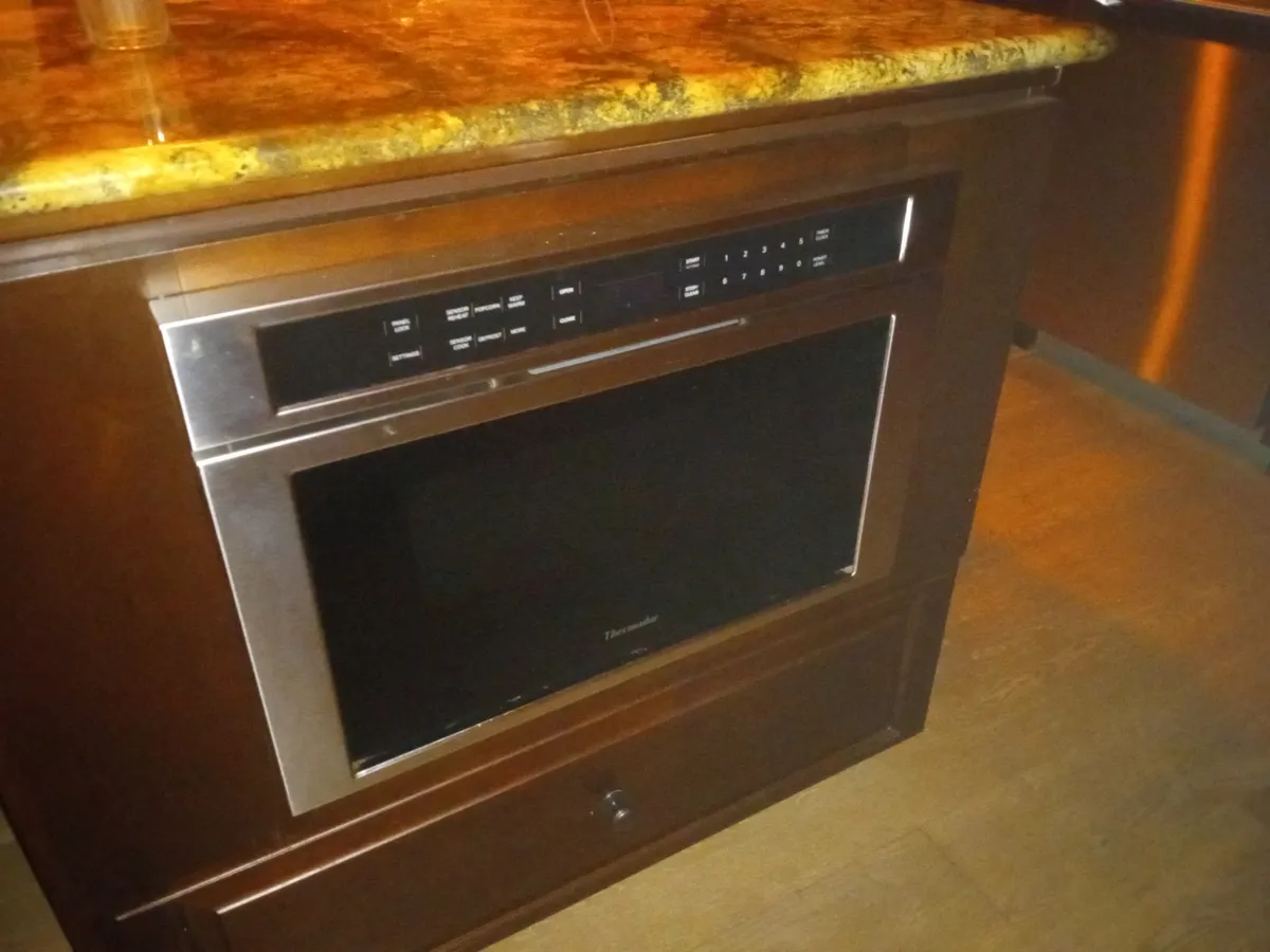 A microwave built into a kitchen island cabinet