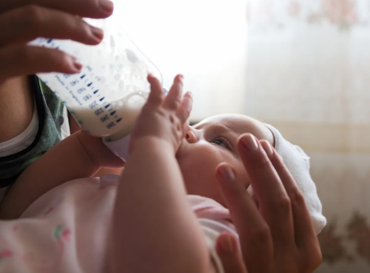A baby being fed from a bottle