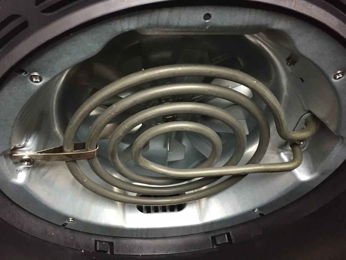Interior of an air fryer showing the heating element above the basket