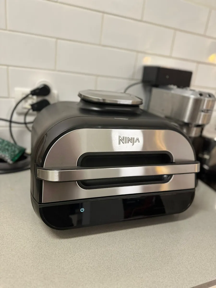 A larger multi-function air fryer and grill unit, shown for comparison