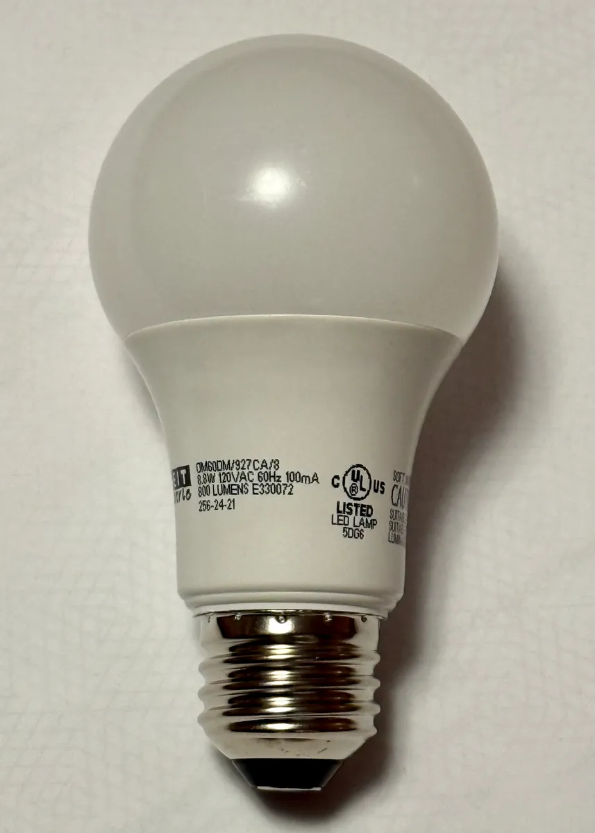 An LED bulb showing its lumen rating on the packaging
