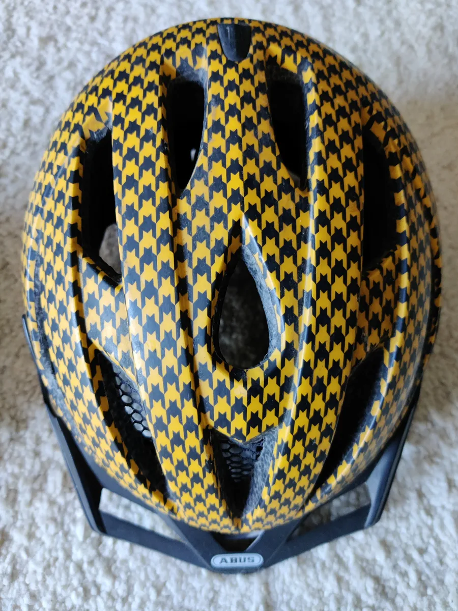 A white bicycle helmet showing the retention cradle and strap system