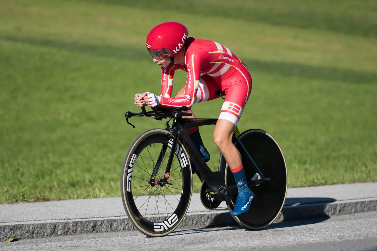 A cyclist racing in an aerodynamic time trial helmet