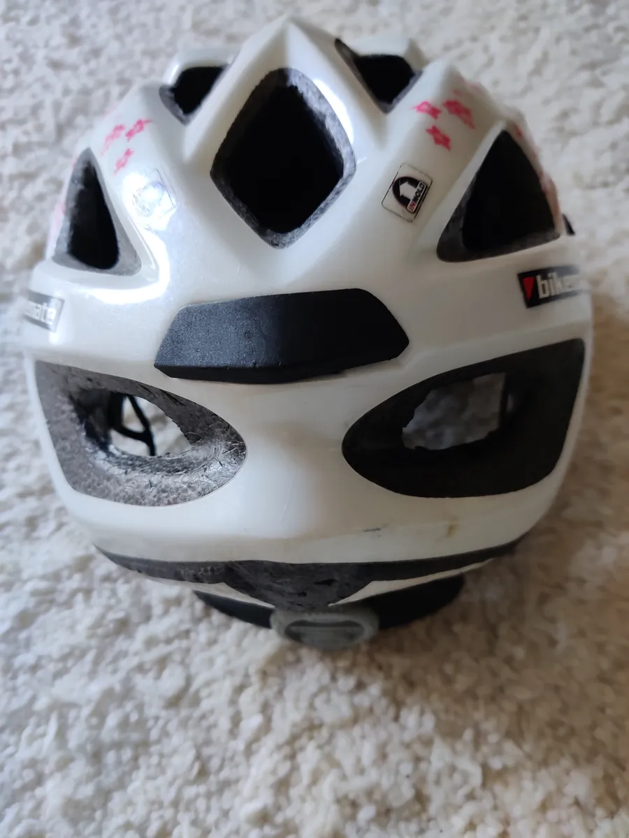 A white bicycle helmet seen from above showing its vents