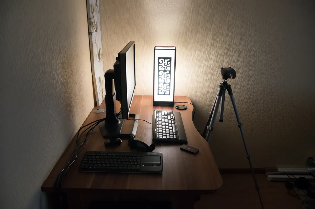 A tidy wooden computer desk with a monitor, keyboard and chair
