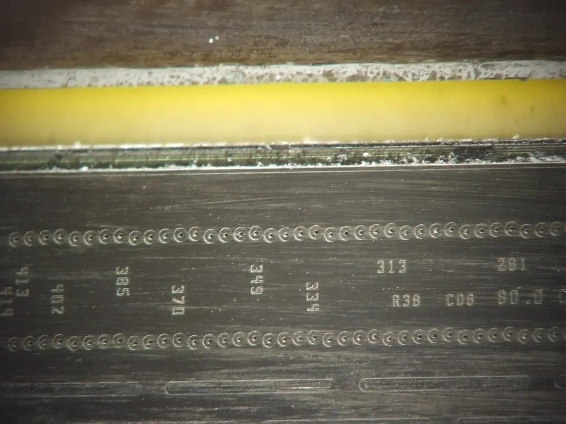 Close view of an inkjet print head showing the nozzle plate