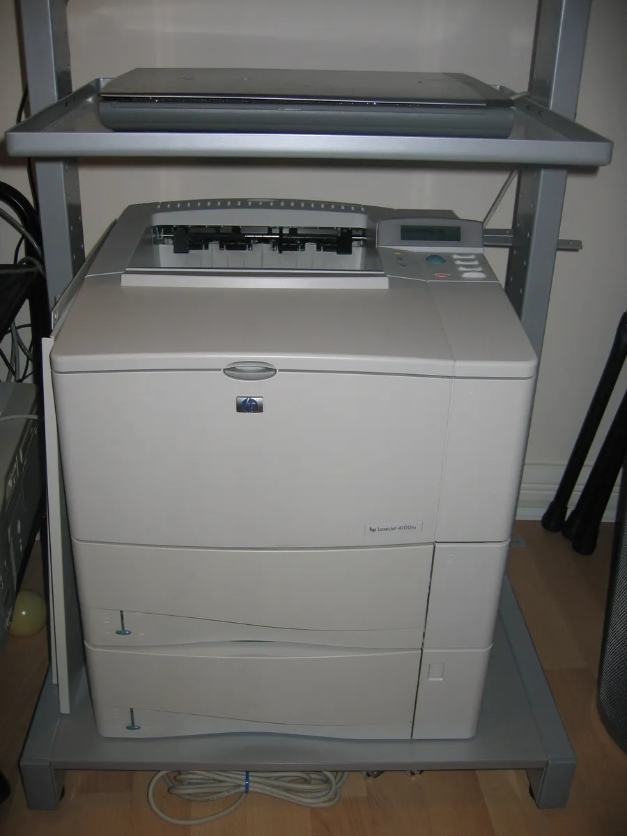A laser printer next to a flatbed scanner on a desk