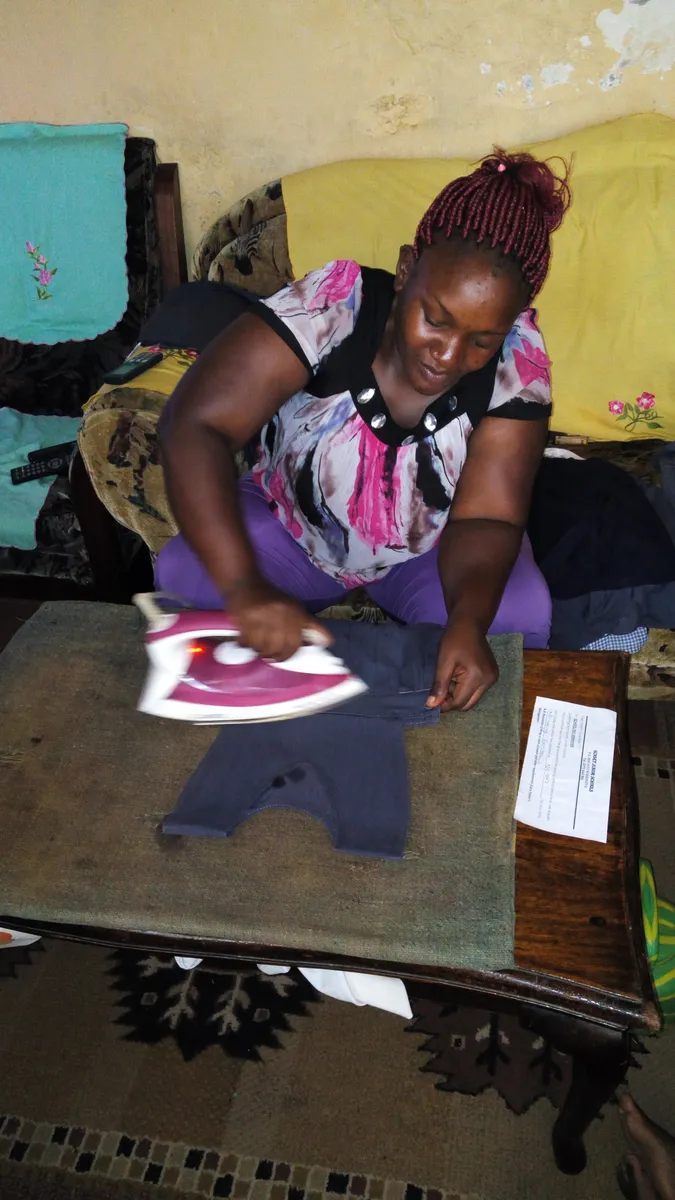A person ironing clothing at home
