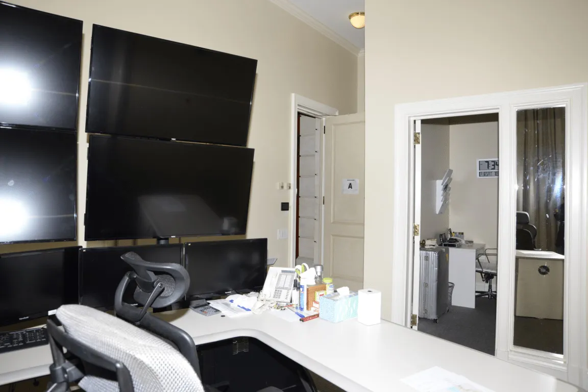 A modern office space with ergonomic chairs and a well-organized desk area with monitors positioned at eye level