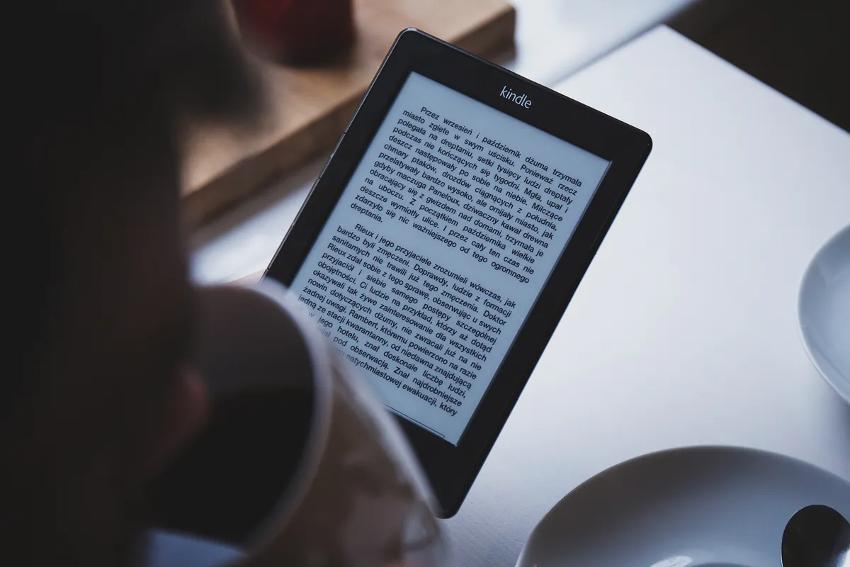 A person reading on an e-book reader