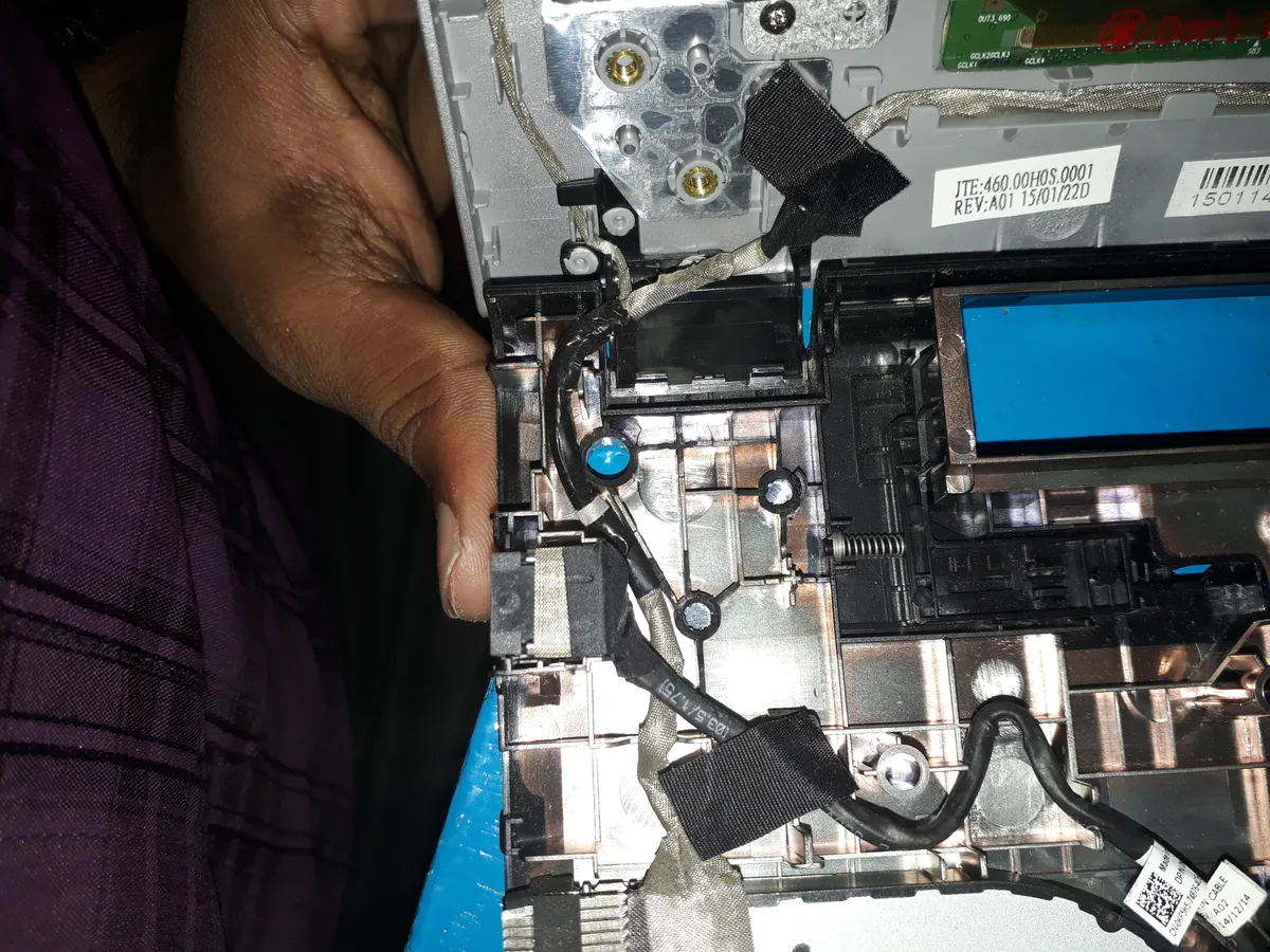 A laptop being repaired with its internals exposed