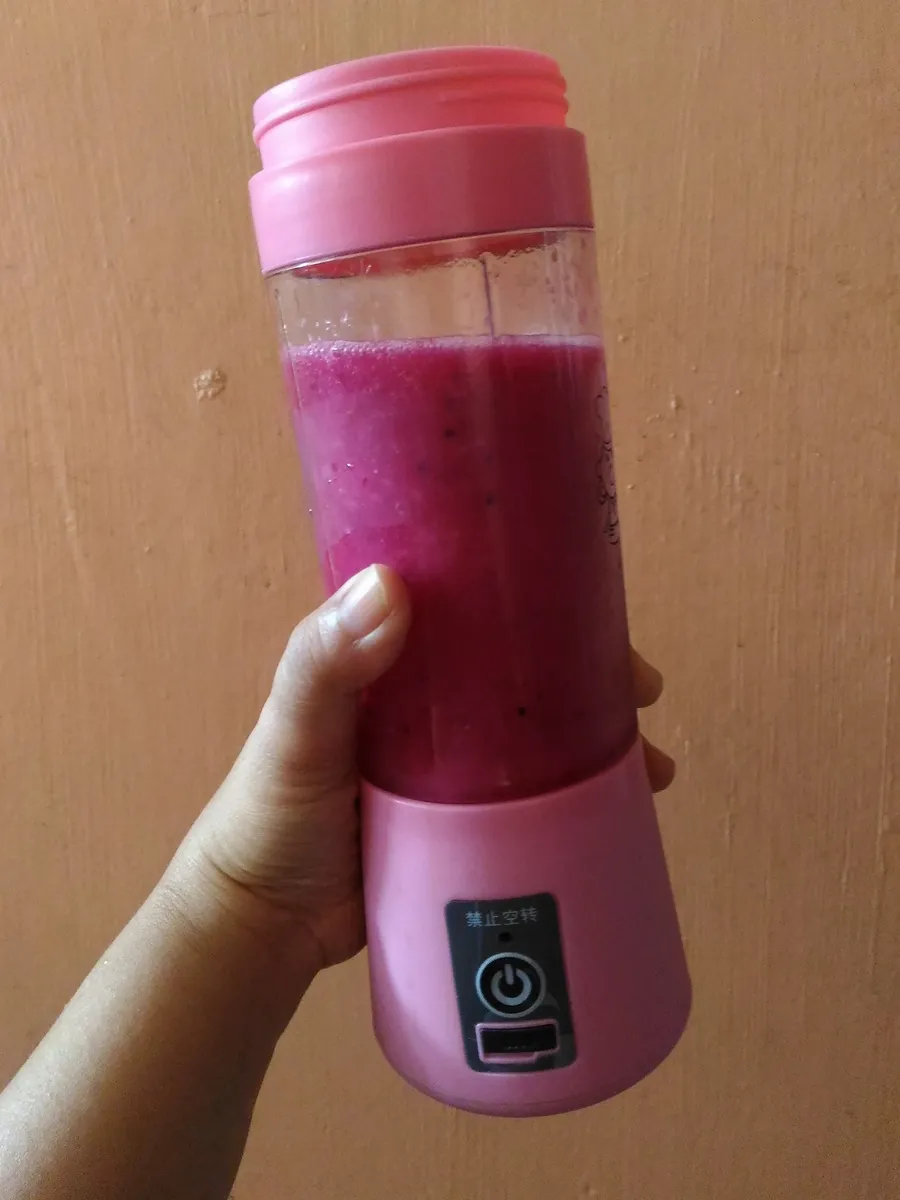 A small portable personal blender with a drinking bottle jar