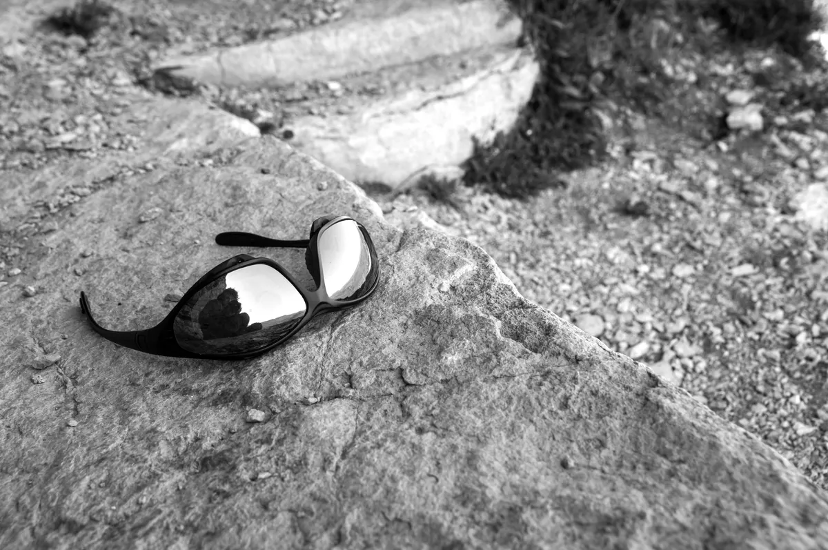 Mirrored sports sunglasses reflecting the landscape