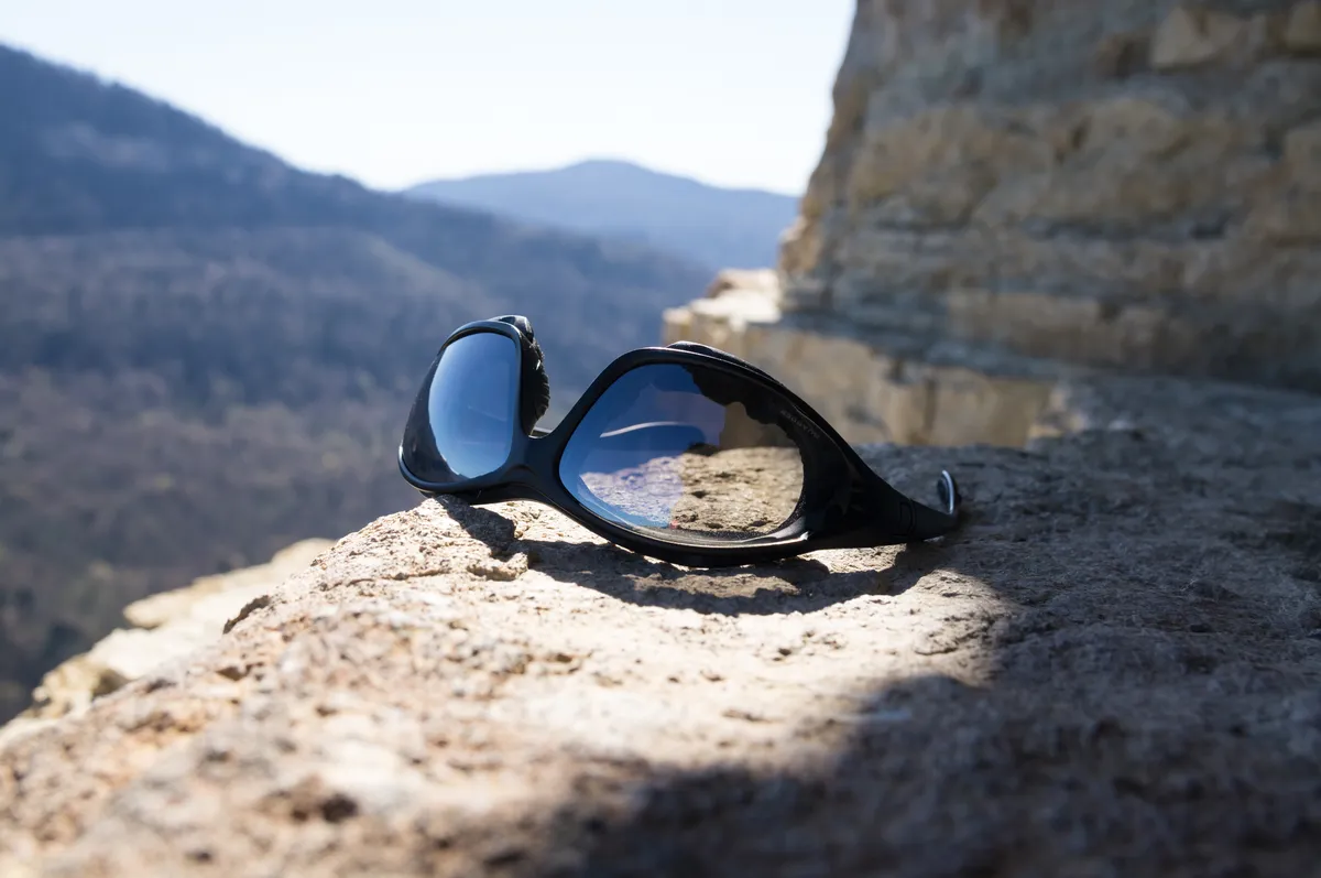 Wrap-around sports sunglasses worn outdoors