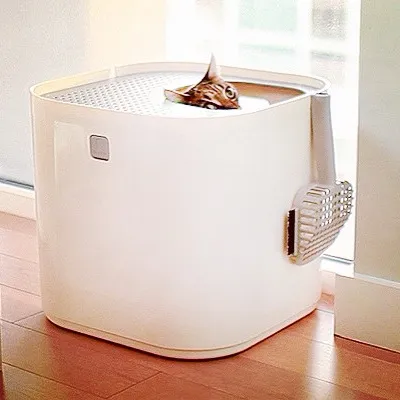 A modern enclosed cat litter box design, shown for comparison against traditional open trays