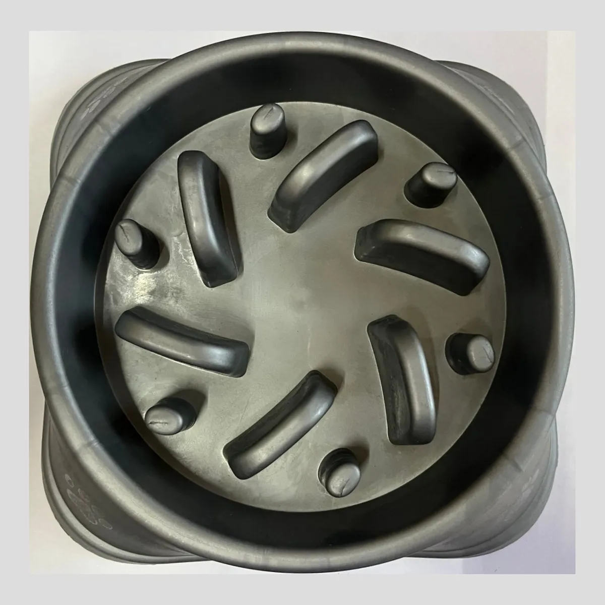 A slow feeder dog bowl with a maze pattern