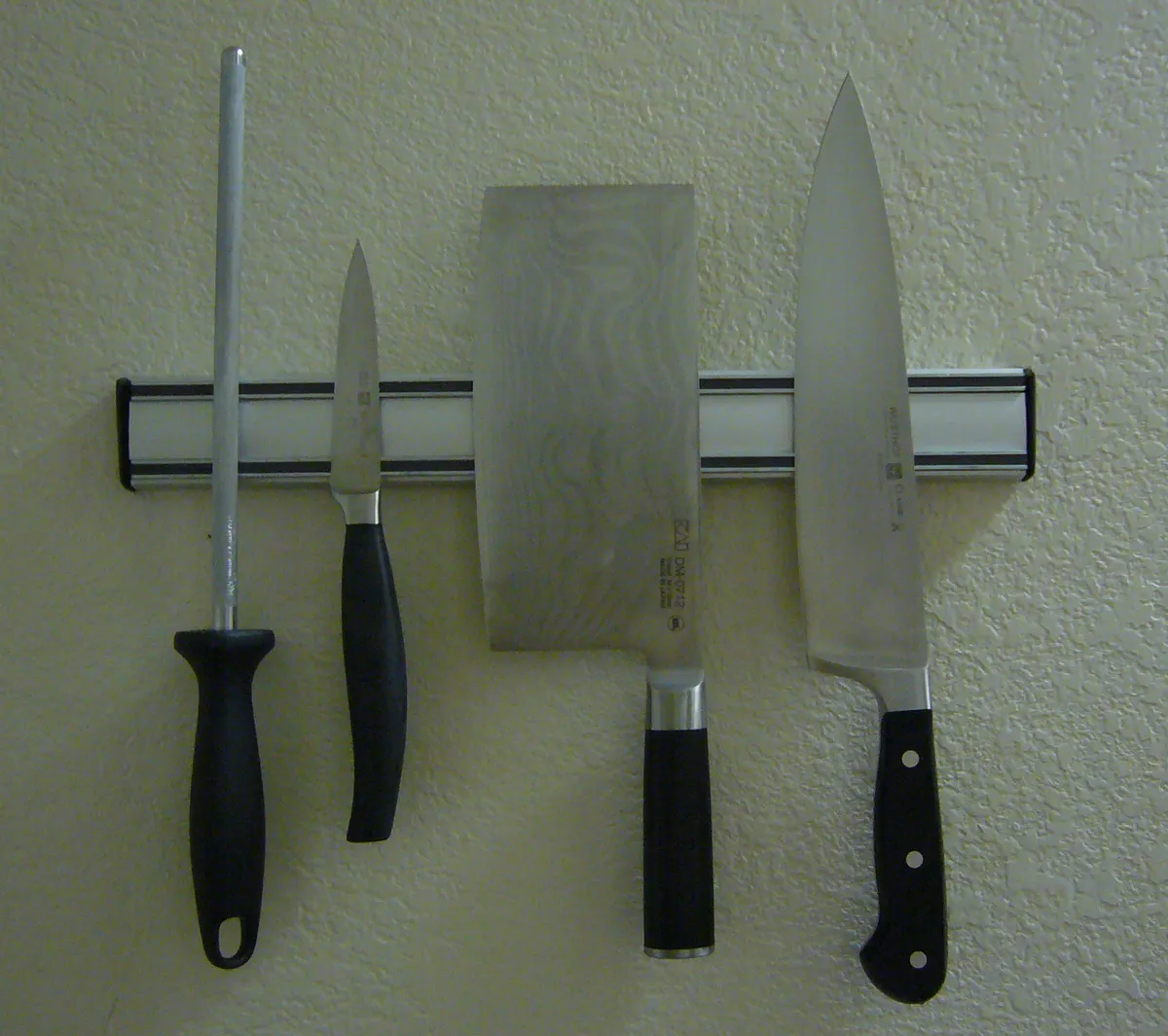 Kitchen knives stored on a magnetic rack