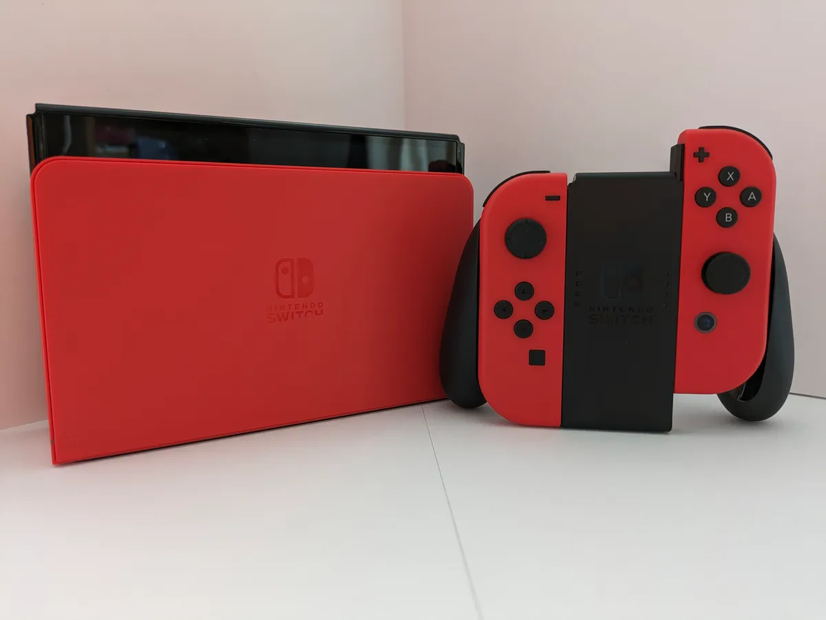A handheld game console held in both hands