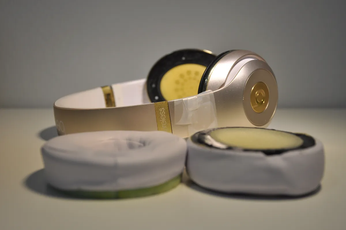 Headphones partly disassembled on a bench for repair