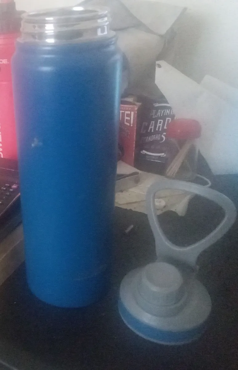A stainless steel water bottle on a surface