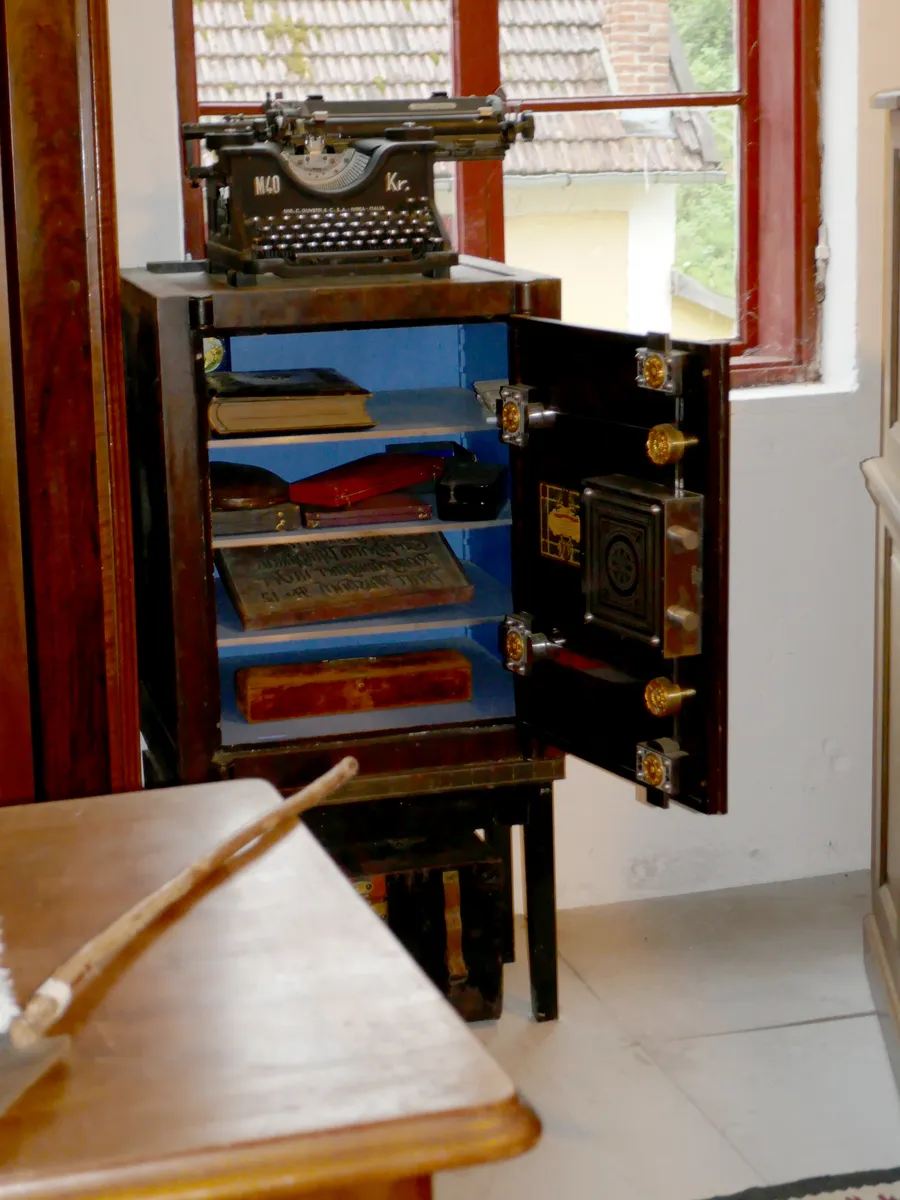 An old heavy iron safe with a decorated door