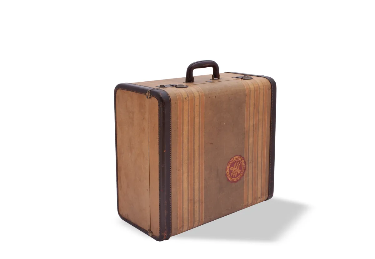 A hard-sided suitcase with strap detailing