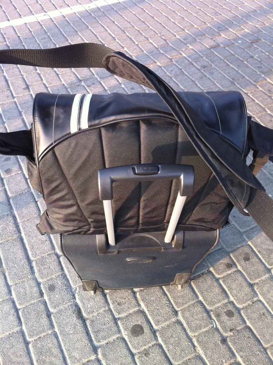 A soft travel bag packed and standing upright
