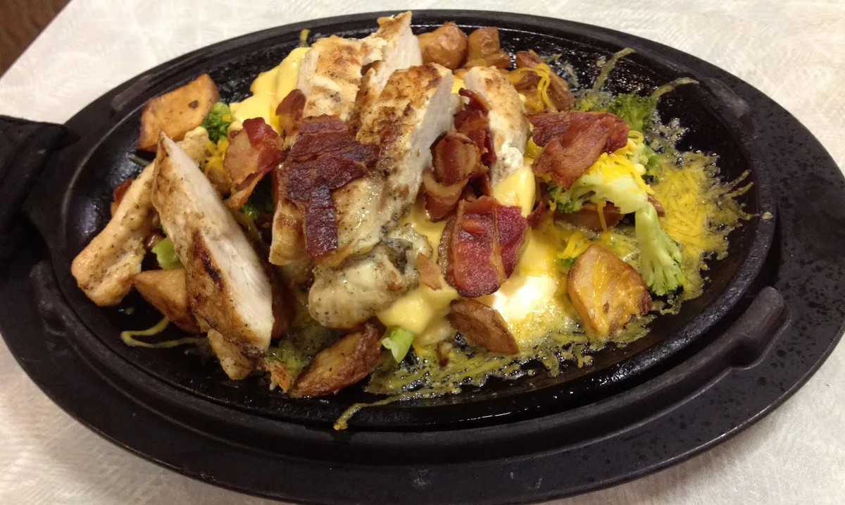 Chicken and bacon cooking in a skillet