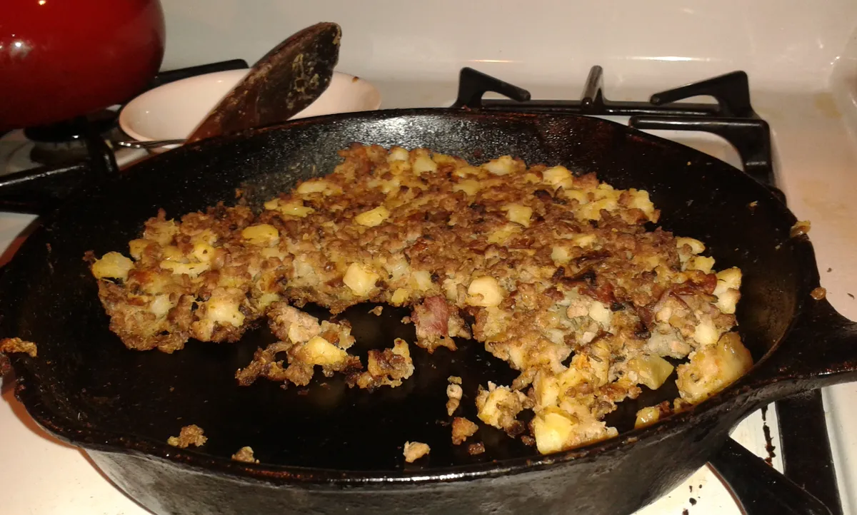 A hash cooking in a heavy pan