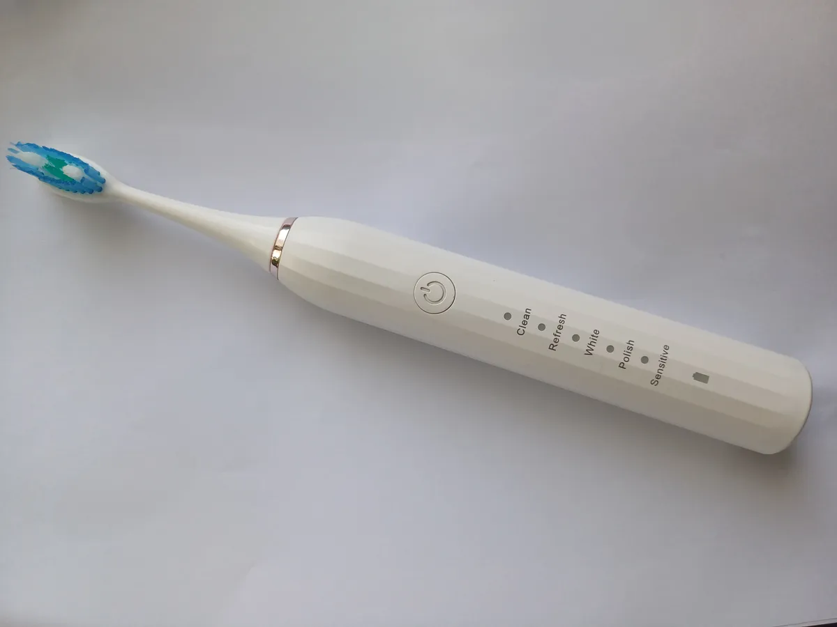 An electric toothbrush with its brush head attached