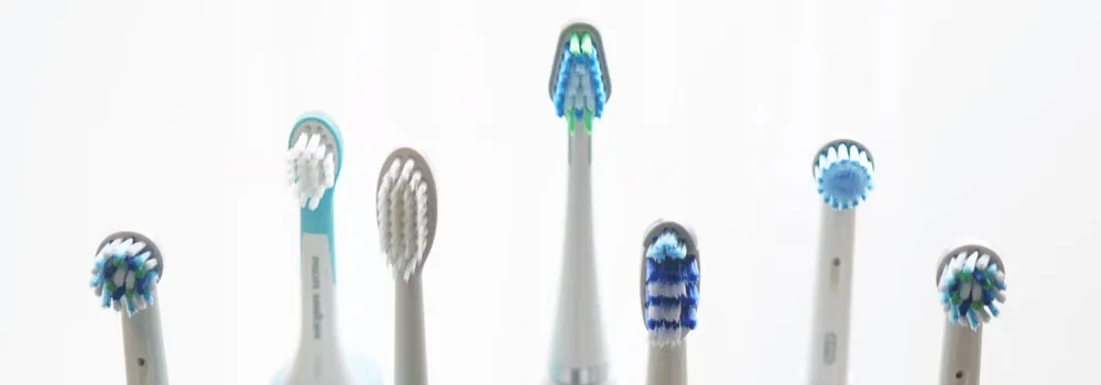 Electric toothbrushes with accessories laid out