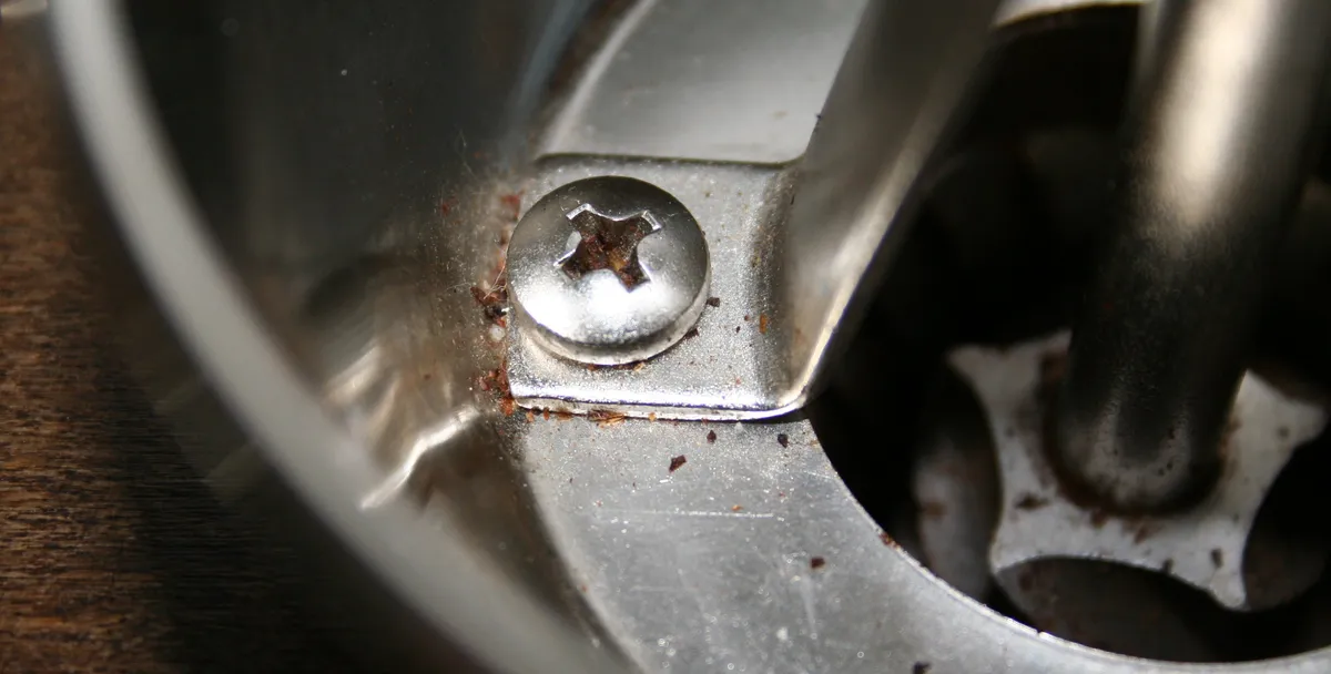 A grinder hopper opened to show the burrs inside