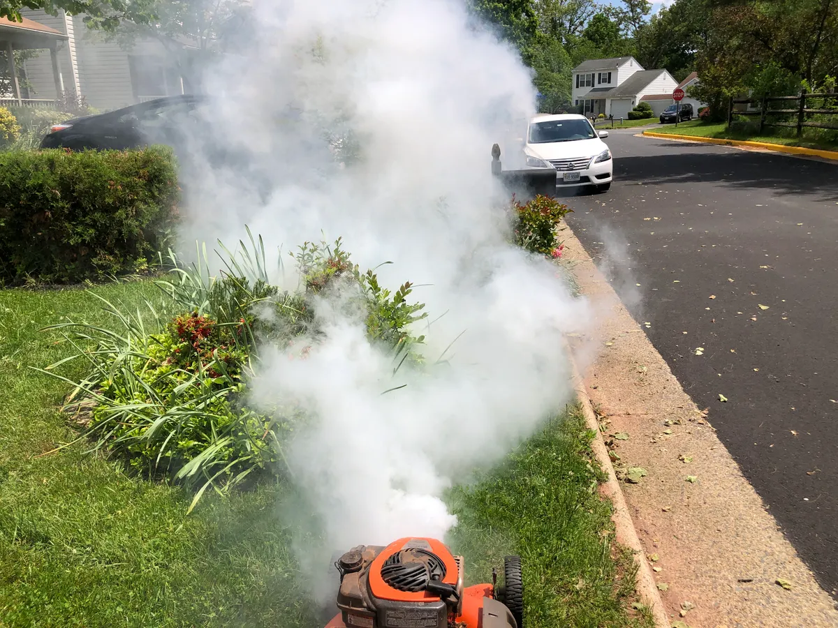 Smoke coming from a petrol lawn mower engine