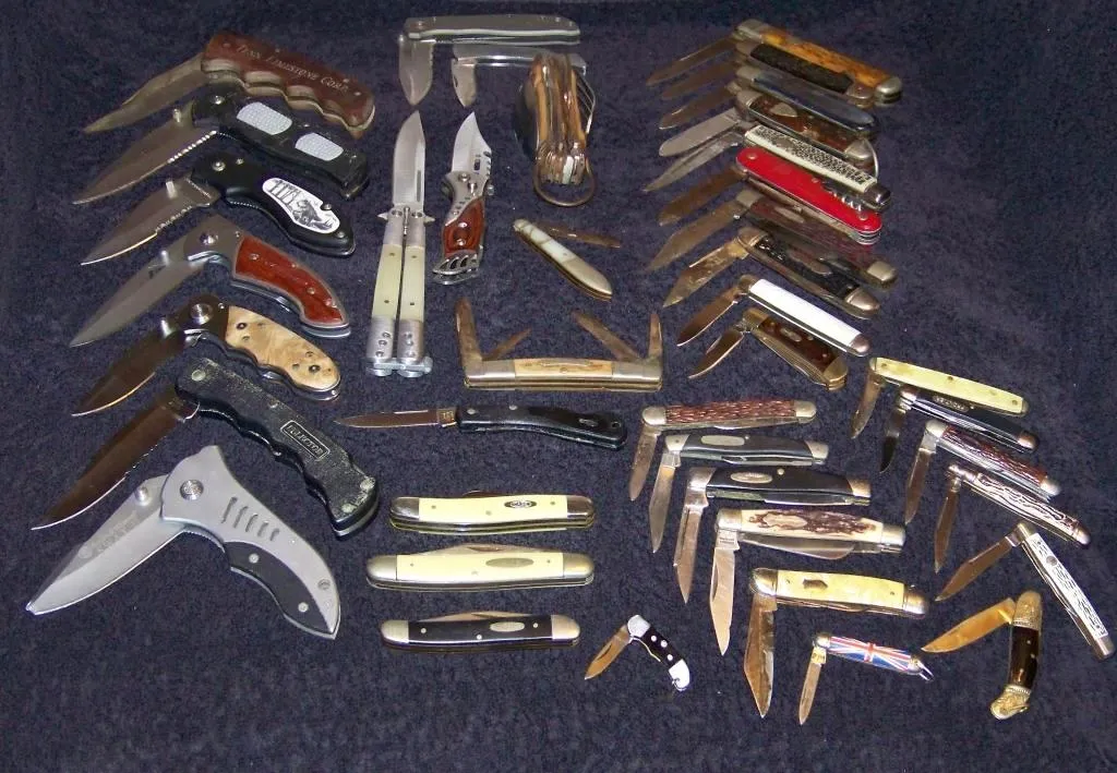 Several folding pocket knives laid out