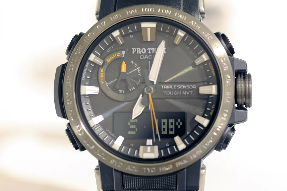 A watch showing a digital compass display