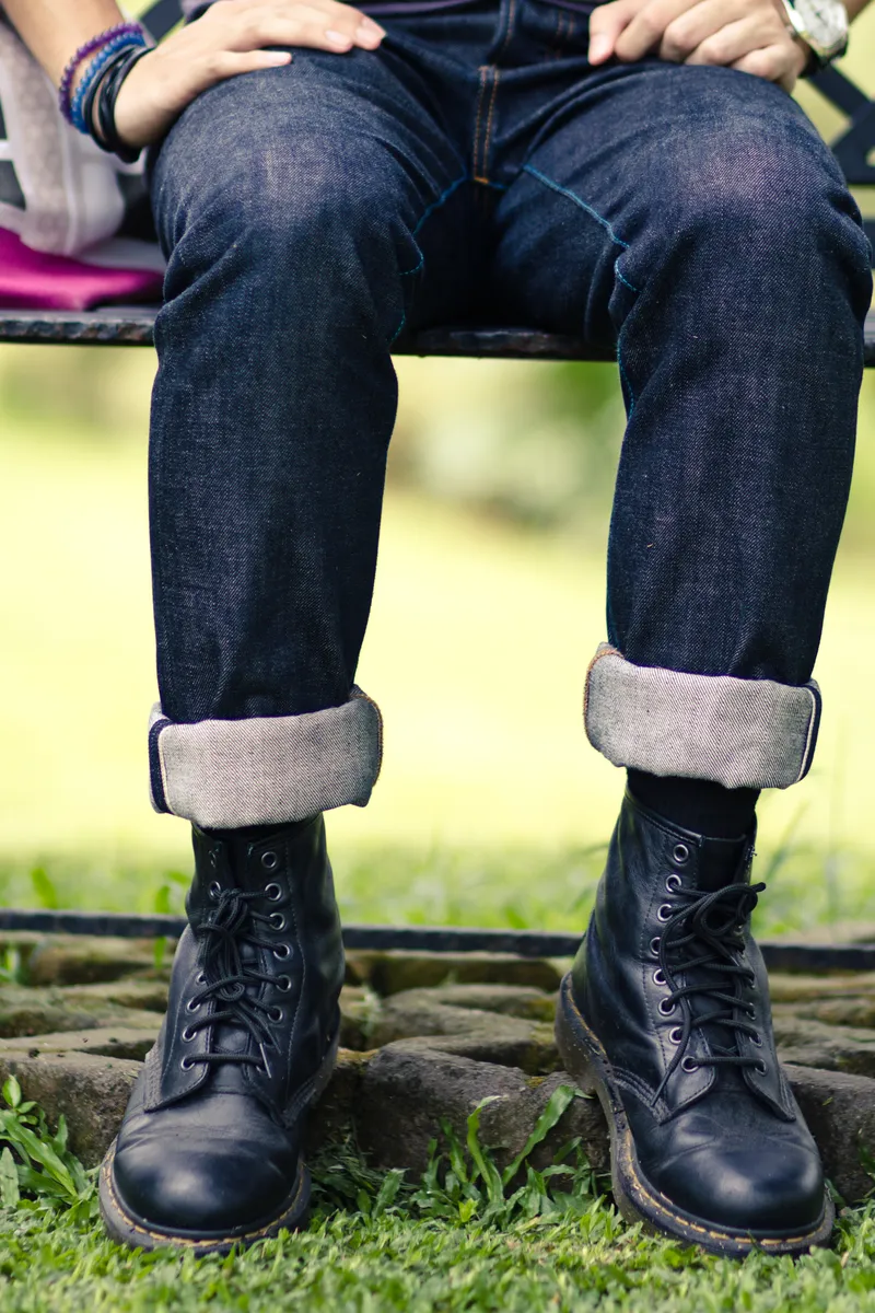 A pair of jeans worn with boots