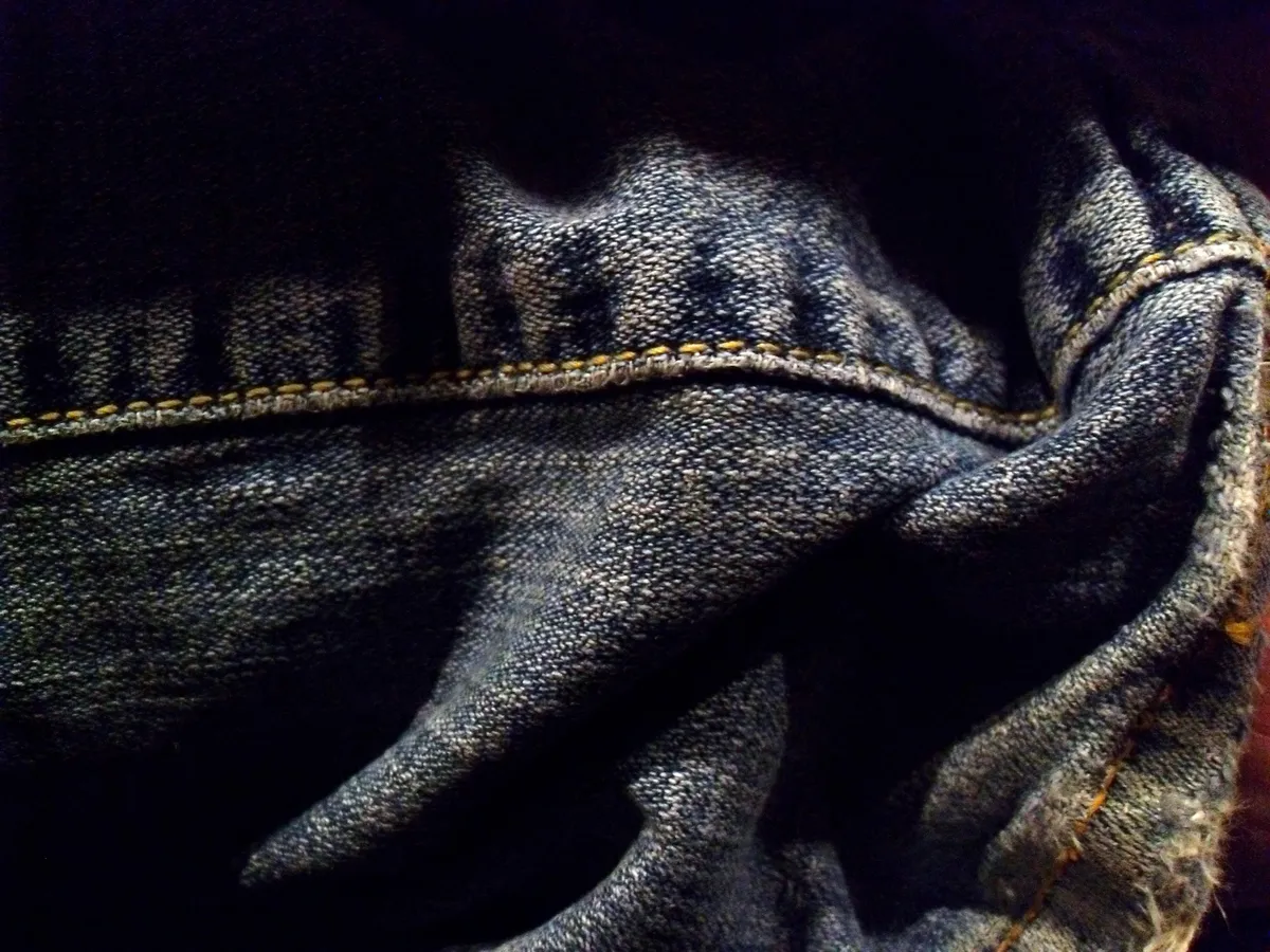 Worn denim jeans showing fabric creases
