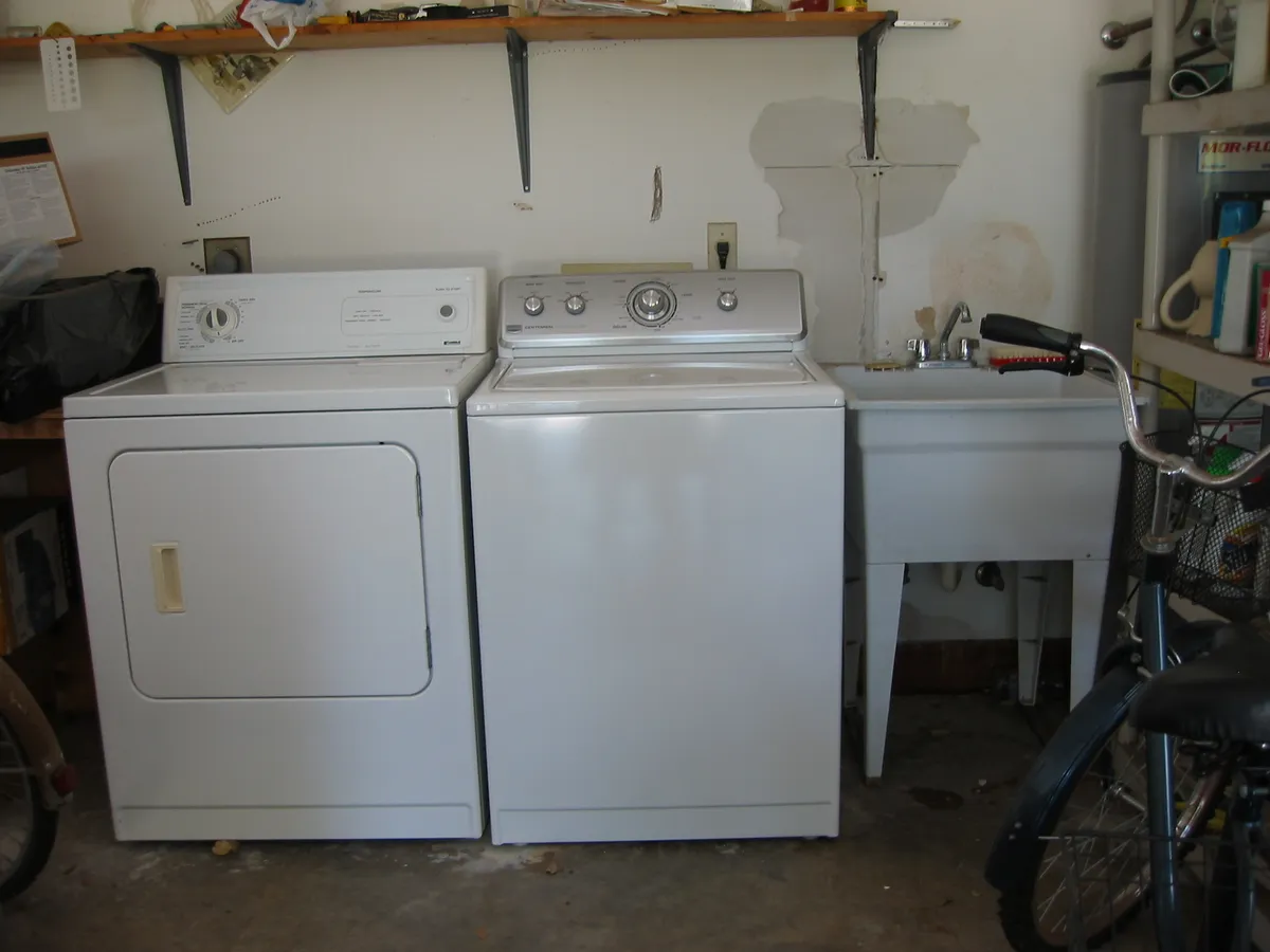 A newly installed washing machine in a laundry space