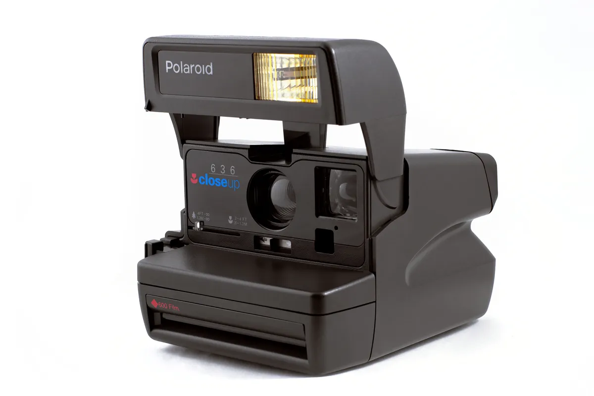 An instant camera with a close-up lens attachment