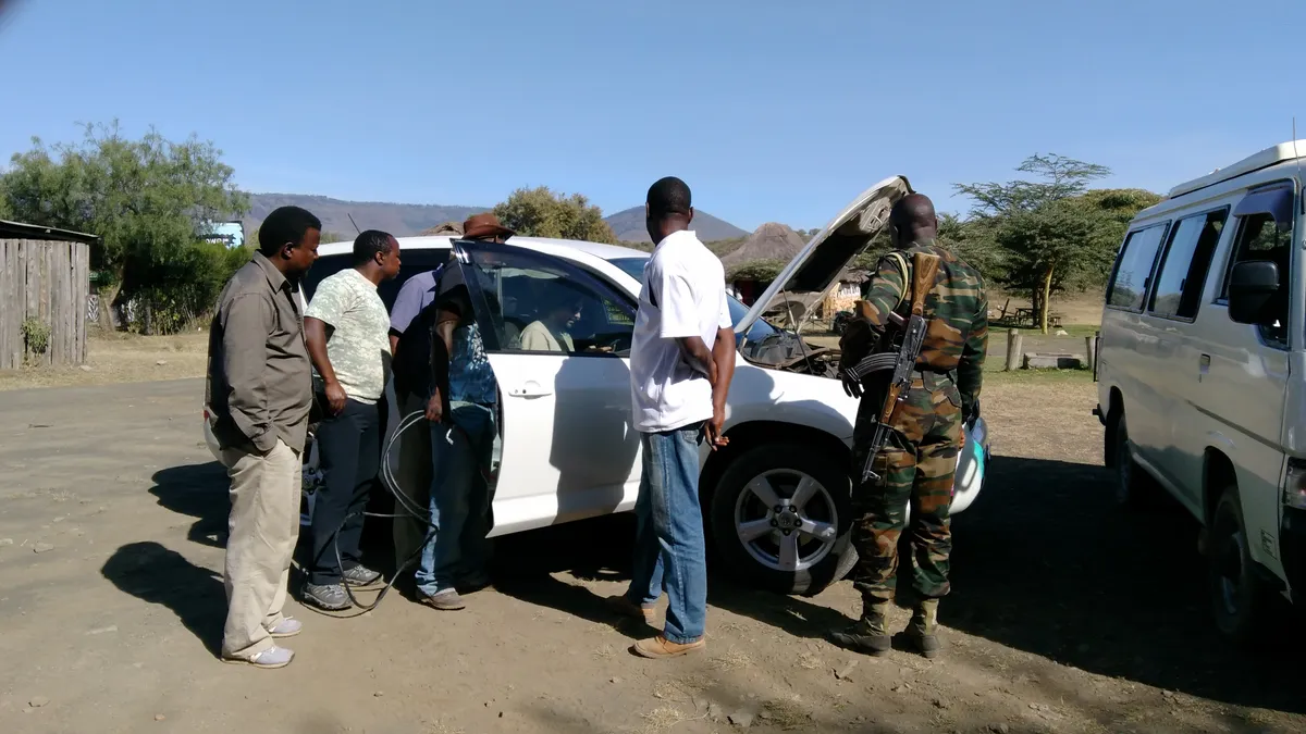 A car stopped at the roadside with a flat battery