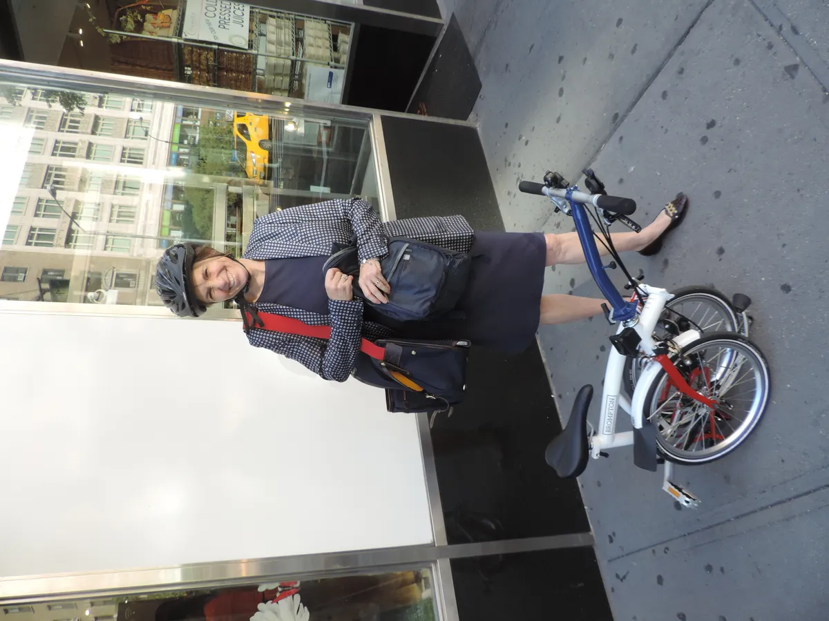 A folding bicycle being ridden in a city
