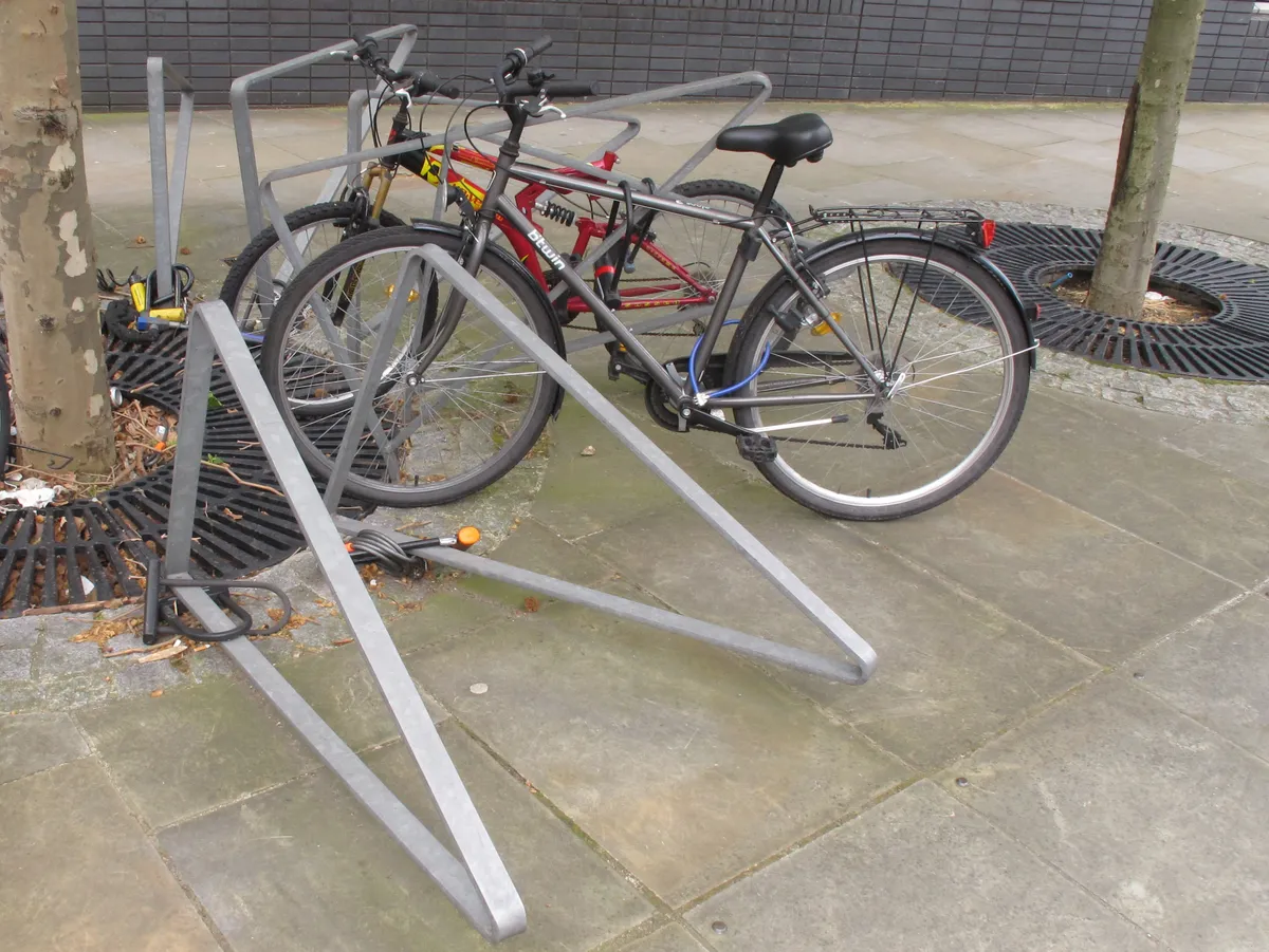 Bicycles locked to racks at a commuter station
