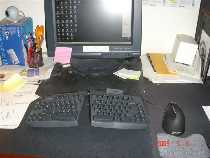 An ergonomic keyboard and matching mouse on a desk