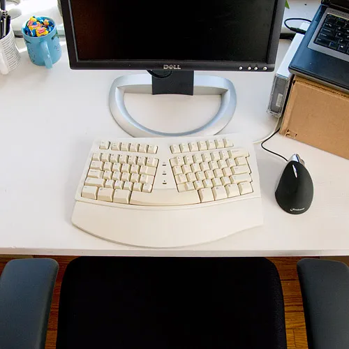 Overhead view of a desk with keyboard, mouse and monitor
