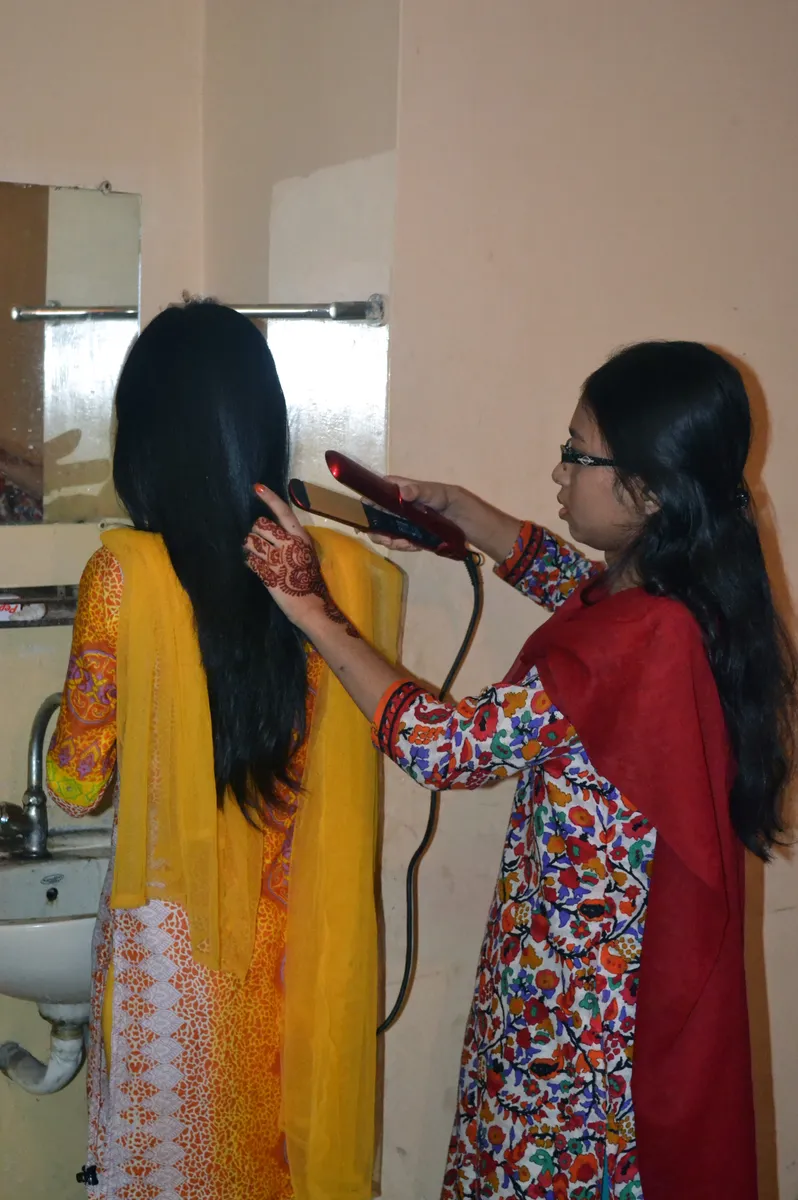 Hair being smoothed with a flat iron